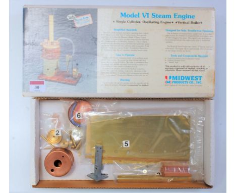 A Mid-West Products Company Incorporated white metal and wooden kit for a Model 6 steam engine, comprising of vertical boiler
