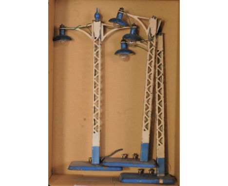 Three Hornby electric lamp standards: two 1933-8 No. 1E lighter blue base and finial and a No. 2E same colours, one finial mi