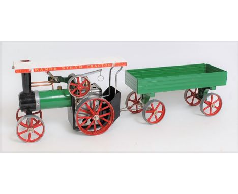 A Mamod TE1A steam traction engine comprising green and red body fitted with original scuttle and burner, together with a Mam