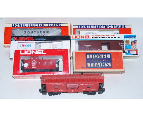 Seven Lionel freight wagons: Southern Comfort billboard reefer 6-9834 (M-BNM); 1992 TTOS Convention car box containing Southe