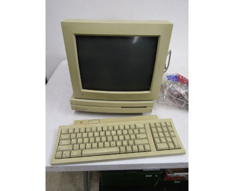 Vintage Macintosh computer model m0350 and monitor