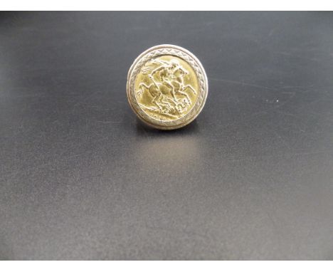 1913 George V full sovereign in a 9ct gold sorround ring size T 16.84g total weight. Has had historic repair the shank