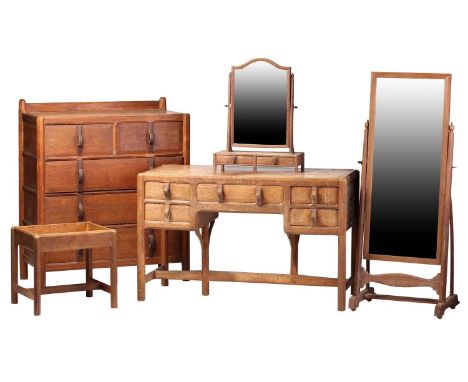 A Gordon Russell bedroom suite in English brown oak, c.1925, comprising: a dressing table with rectangular moulded top, suppo