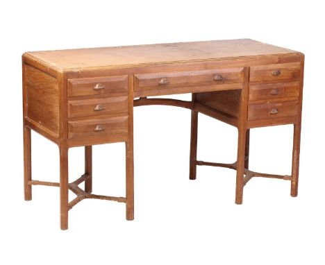 A Gordon Russell Workshops English walnut dressing table, c.1925, with rectangular moulded top, one long drawer above the kne