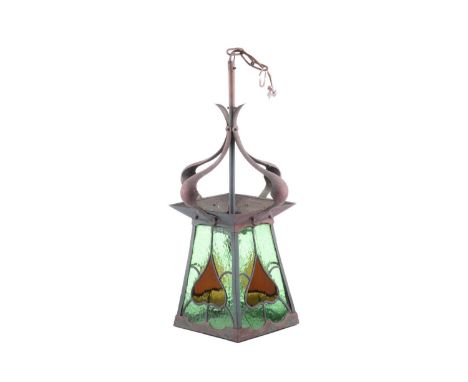 An Arts and Crafts brass and leaded glass ceiling lantern, with four shaped and studded upper supports over four coloured gla