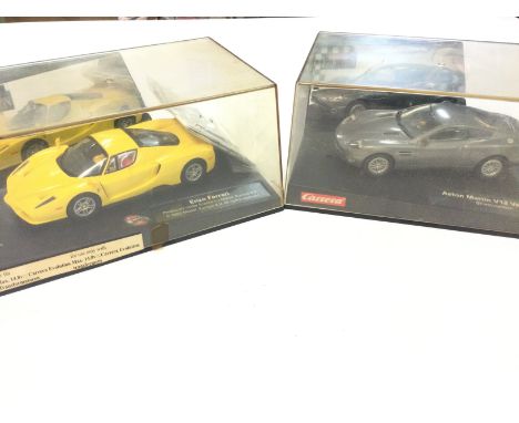 2 Boxed Carrera Evolution Slot Cars. A Enzo Ferrari and a Aston Martin V12 Vanquish.