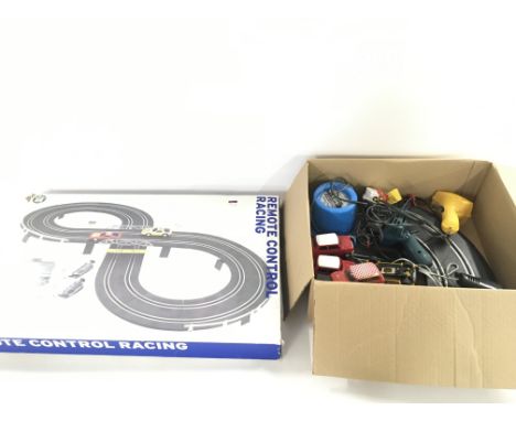 A collection of Scalextric items and a remote control racing track.