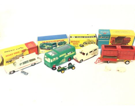 4 Boxed Vehicles including Dinky Ambulance #263. A Matchbox Racing-Car Transporter #K-9. A Budgie Toys Ambulance and a Corgi 