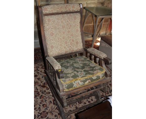 A 19th century American rocking chair, upholstered in a floral tapestry, and another American rocking chair (for restoration)
