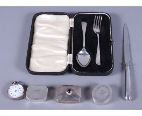 A silver spoon and fork, in case, three silver pill boxes, a silver handled letter opener and a silver cased fob watch