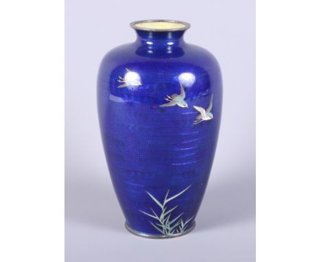 A 1920s Japanese cloisonne baluster vase decorated with three birds in flight on a blue scale ground 7 1/2" tall.