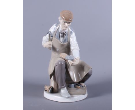 A Lladro ornament of a cobbler art work, 10" high, and a Lladro porcelain model 'Lamplighter'