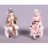 A pair of late 19th century Continental porcelain figures, seated musician and a woman in period