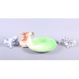 An 18th century Continental model of a tiger, 4 1/4" long (leg restored), a ceramic dish with a