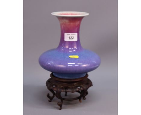 A Chinese purple flambe glazed pottery squat globular shaped vase, on hardwood stand with four scroll feet, 7 1/4" high