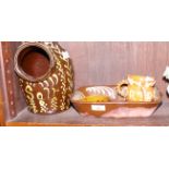 A slipware two-division dish, 11" wide, a similar three-handled tyg dated 1653, 3 1/2" high, and a