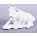 An 18th century Delftware model of a recumbent cow, 6" long (horn restored), and a green glazed