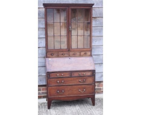 A late 19th century mahogany and banded bureau bookcase, the upper section enclosed lattice glazed doors over four small draw
