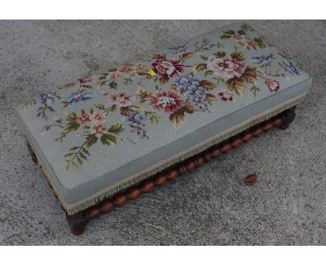 A rectangular footstool, on bobbin turned underframe