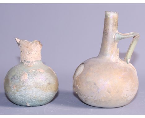 A Roman glass bulbous flask, 4 1/2" high (damages) and a smaller Roman glass flask (damaged rim) 3 1/2" high, a blow moulded 