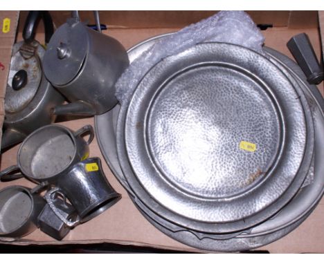 A collection of hammered pewter plates, trays, teasets, etc