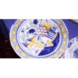 A Delft pottery blue and white charger decorated with sprays of flowers within a cross hatched