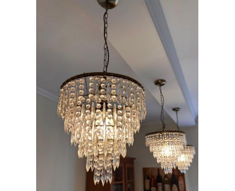 A set of three waterfall chandeliers, three tier of cut glass spearhead drops 