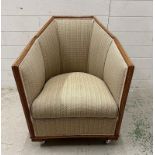 An oak framed Art Deco lounge chair in a beige upholstery