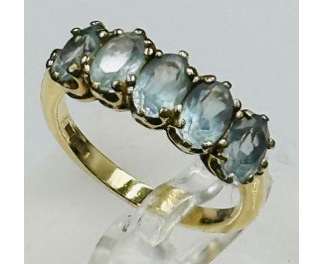 A five stone blue topaz 9ct gold ring approximate size N and weight 2.9g