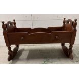 A 19th Century mahogany rocking cradle with carved stars to ends