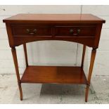 A two drawer veneered side table with shelf under and on turned legs (H76cm W66cm D32cm)