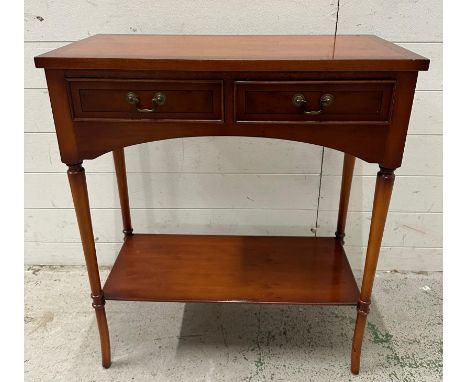 A two drawer veneered side table with shelf under and on turned legs (H76cm W66cm D32cm)
