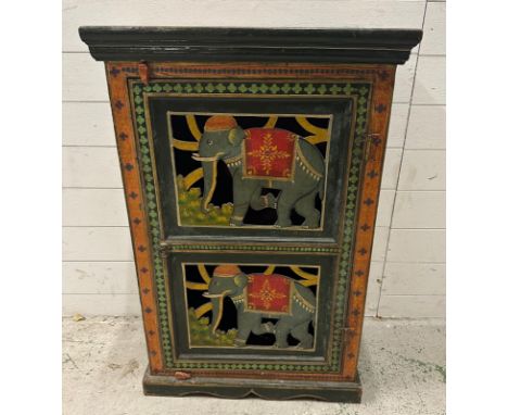 An Indian folk art painted cupboard, the doors featuring elephants in traditional costume and the sides and top painted with 