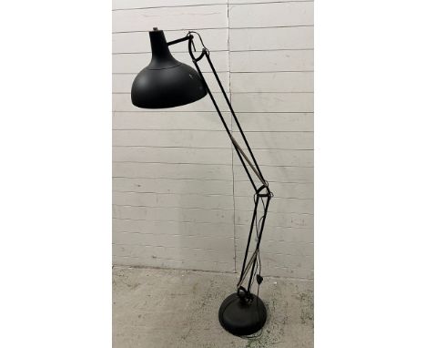 An industrial style adjustable floor lamp in black 