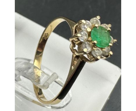 An 18ct gold emerald and diamond ring, approximate size N and weight 1.8g