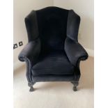 A blue upholstered wing back arm chair on cabriole legs with claw and ball feet by Duresta