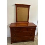 A mahogany veneer sideboard with a bevel edged mirror over and multiple long and short drawer