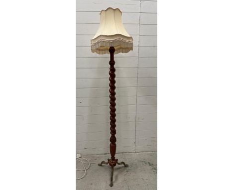 An oak barley twist floor lamp on brass lions paw tripod legs 