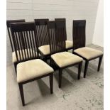 A set of six contemporary stick back dining chairs upholstered in beige