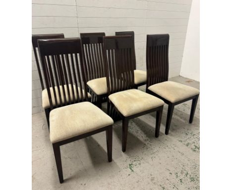 A set of six contemporary stick back dining chairs upholstered in beige 
