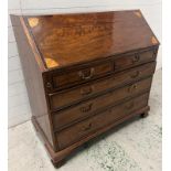 A mahogany inlaid bureau opening to pigeon holes and drawers (H110cm W110cm D59cm)