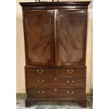 A mahogany linen press. Two doors opening to five shelves with a two over two chest under. AF.
