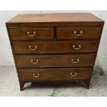 An inlaid mahogany two over three chest of drawers with brass drop handles