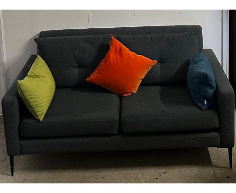 A contemporary charcoal grey two seater sofa with button back cushions (scatter cushions are not included in this lot)
