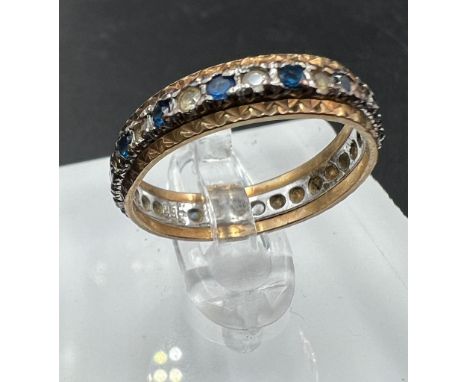 A 9ct gold eternity style, blue stone ring, approximate weight 2.6g and size L