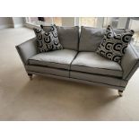 A pair of Duresta two seater sofas in a black and white flecked upholstery and piped in black (H88cm