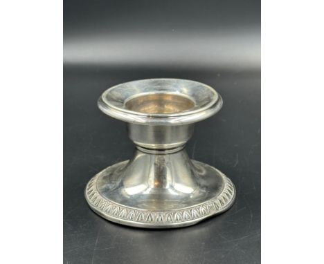 A German silver squat candlestick, approximate 6.5cm H and 9 cm diameter to base.