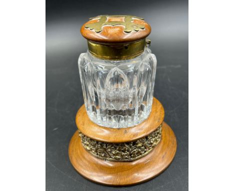 An antique cut glass inkwell with brass fitments on wooden stand. 12.5cm H