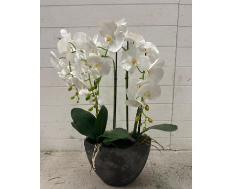 A faux white orchid in granite style planter 