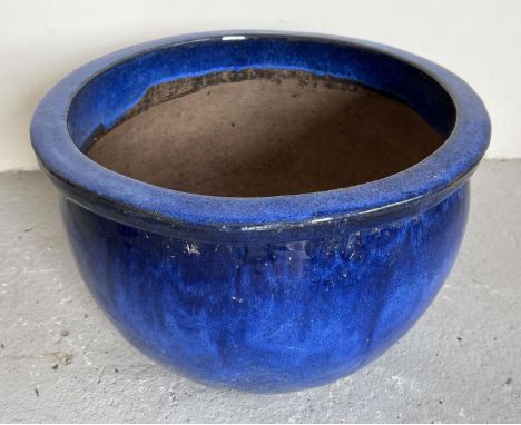 A large modern blue glazed garden planter of bulbous form. Approx. 25cm tall x 40.5cm diameter. 